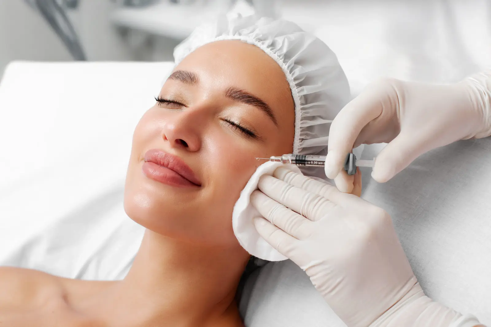 Patient receiving facial injection at medspa, enhancing skin appearance.
